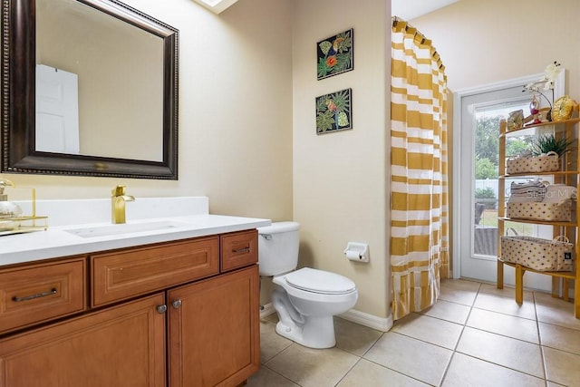 bathroom featuring tile patterned flooring, vanity, and toilet