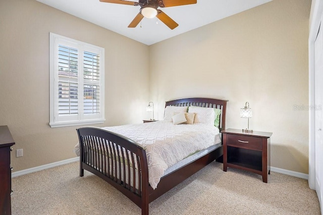 bedroom featuring ceiling fan and light carpet