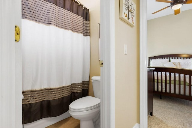 bathroom featuring ceiling fan and toilet