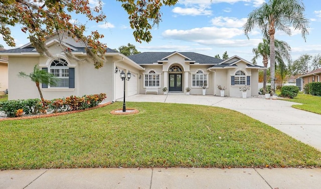 ranch-style home with a garage, a front yard, and french doors