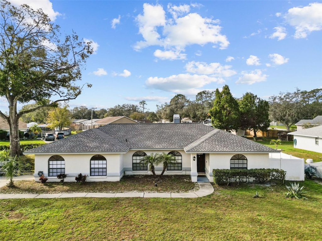 ranch-style home featuring a front yard