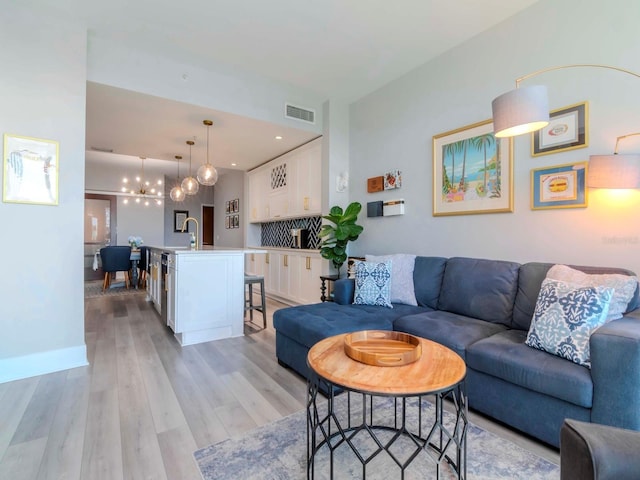 living room featuring light hardwood / wood-style flooring and sink