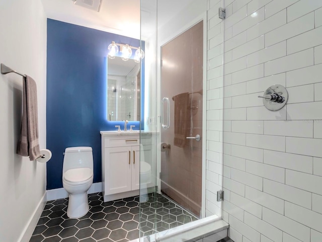 bathroom featuring vanity, an enclosed shower, and toilet