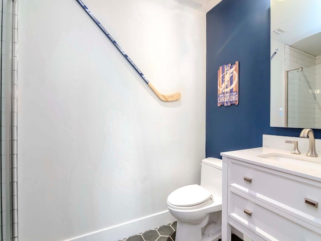 bathroom featuring an enclosed shower, vanity, and toilet