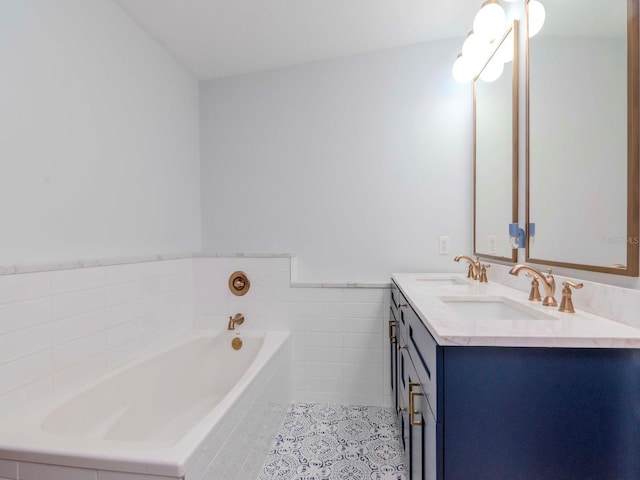 bathroom with vanity, tiled bath, and tile patterned floors