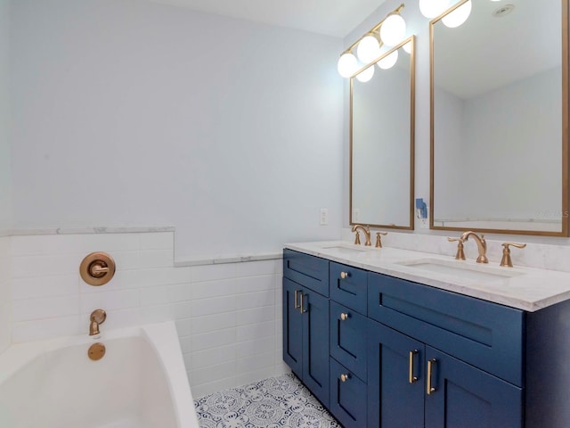 bathroom featuring a washtub, vanity, tile patterned floors, and tile walls