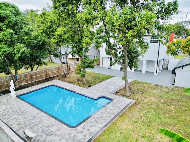 view of pool with a yard and a patio