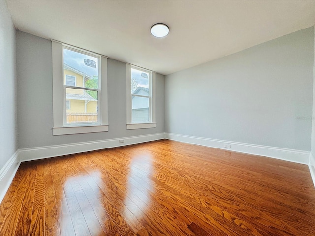 spare room with wood-type flooring