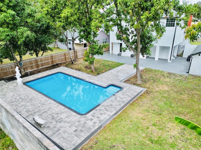 view of swimming pool with a lawn and a patio area