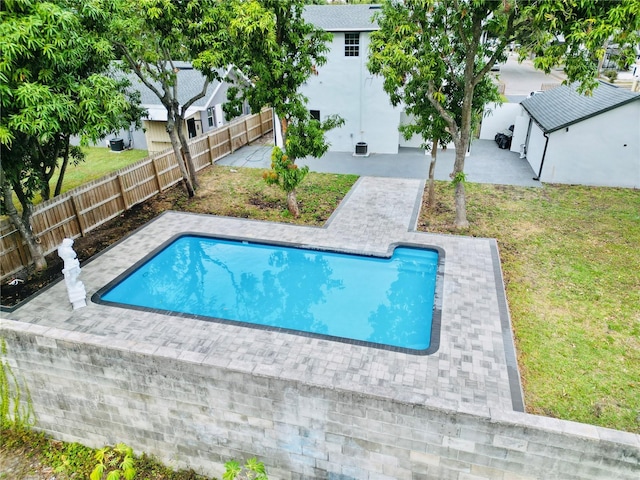 view of swimming pool with a yard and a patio