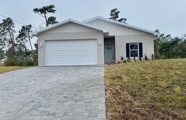 view of front of house with a front yard and a garage