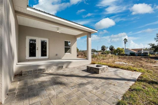 view of patio featuring french doors and a fire pit