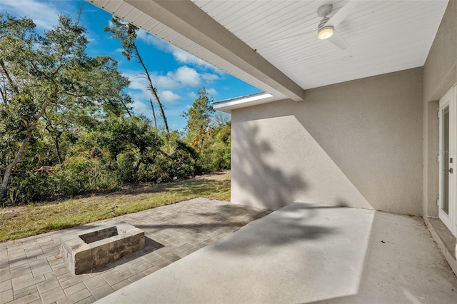 view of patio with a fire pit and ceiling fan