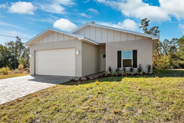 ranch-style house featuring stucco siding, a front lawn, decorative driveway, board and batten siding, and an attached garage