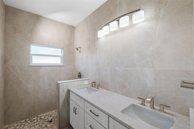 bathroom featuring vanity, tile walls, and a shower