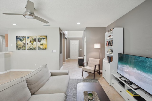 tiled living room featuring a textured ceiling and ceiling fan