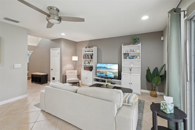 tiled living room featuring ceiling fan