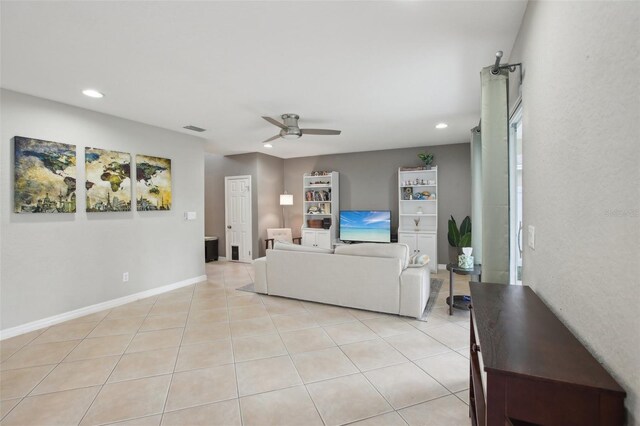 tiled living room with ceiling fan