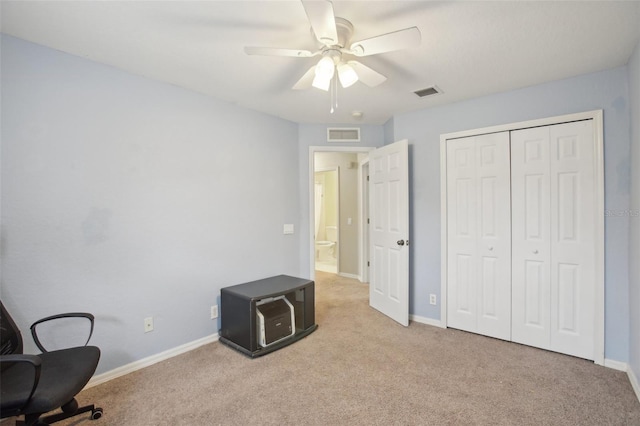 bedroom with ceiling fan, a closet, and light colored carpet