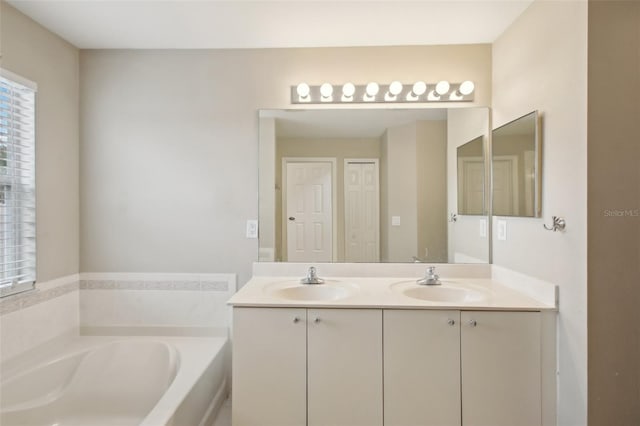 bathroom with a washtub and vanity