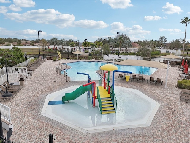 view of pool featuring a playground