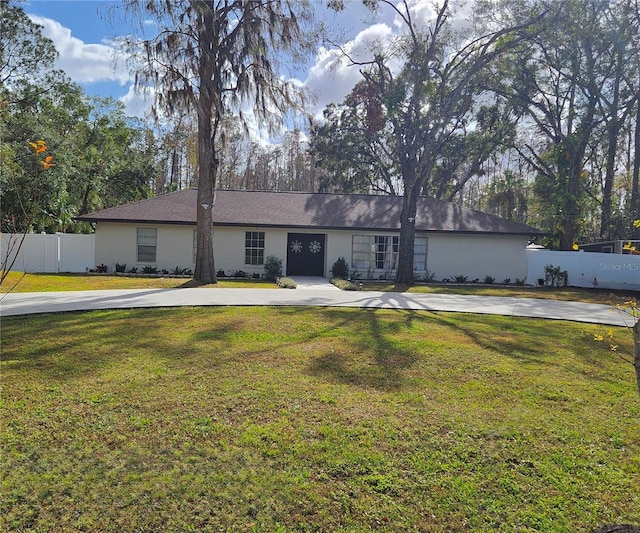 ranch-style home featuring a front yard