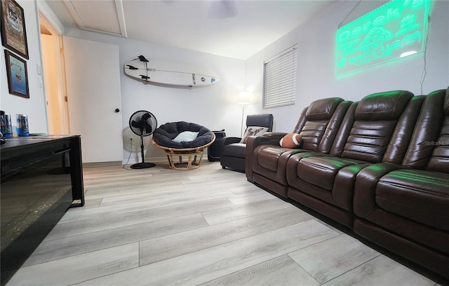 cinema room with light wood-type flooring