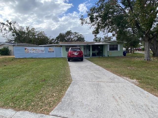 view of front of property with a front yard and a carport