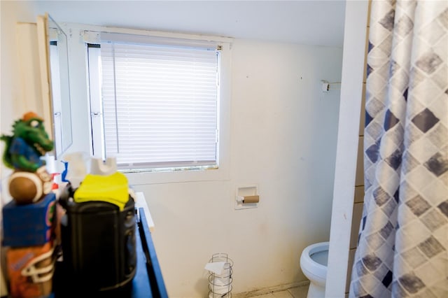 bathroom with walk in shower and toilet