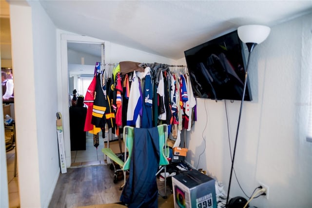 spacious closet featuring hardwood / wood-style floors and lofted ceiling