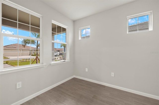 spare room with dark hardwood / wood-style floors