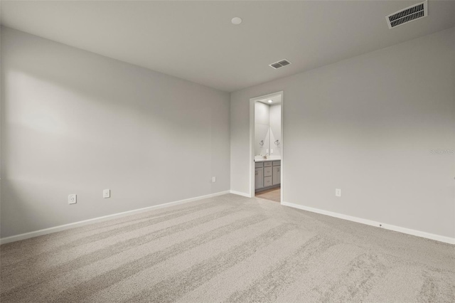 unfurnished room with light colored carpet