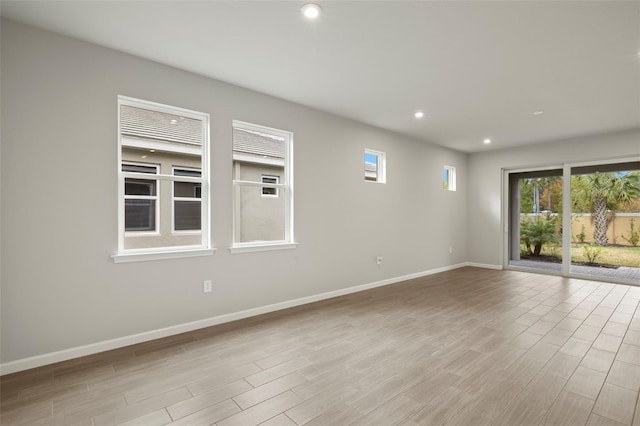 empty room with light hardwood / wood-style flooring