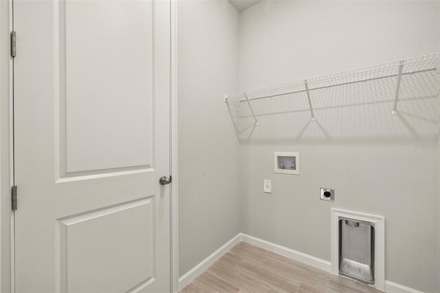 laundry room featuring washer hookup, hookup for an electric dryer, and light hardwood / wood-style flooring