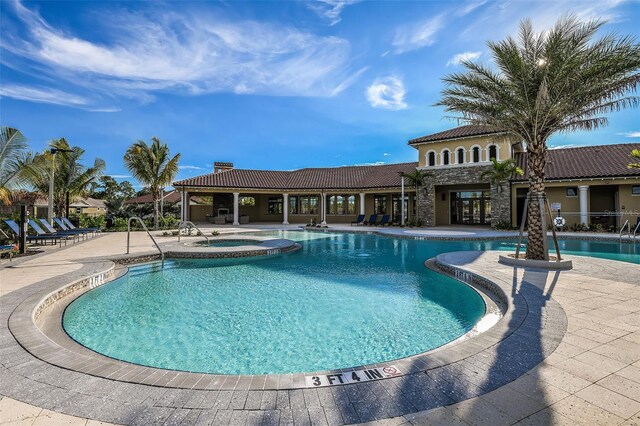 view of pool featuring a patio and a community hot tub