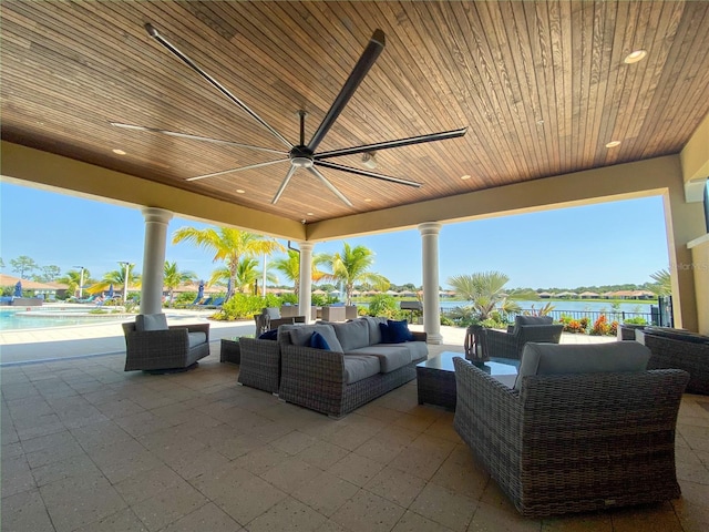 view of patio with an outdoor hangout area, ceiling fan, and a water view