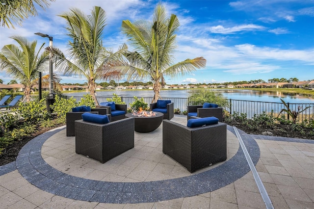 view of patio featuring an outdoor living space with a fire pit and a water view