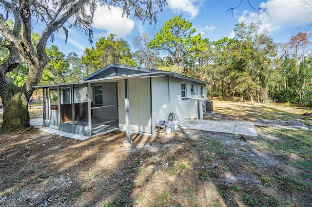 back of property featuring a sunroom and cooling unit