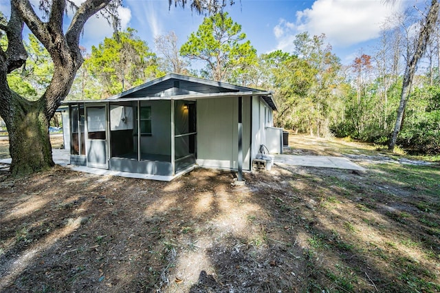 back of property with a sunroom