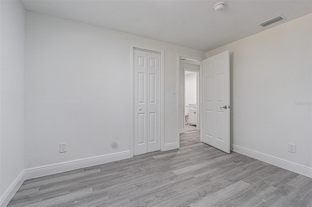 unfurnished room with light wood-type flooring