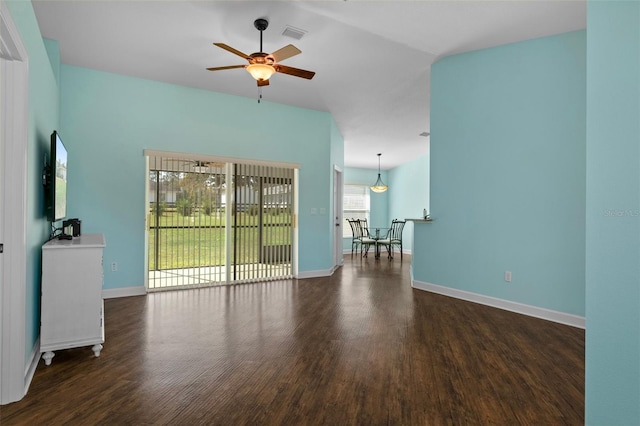 unfurnished living room featuring ceiling fan, dark hardwood / wood-style flooring, and vaulted ceiling