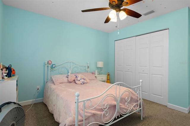 carpeted bedroom featuring a ceiling fan, baseboards, visible vents, and a closet