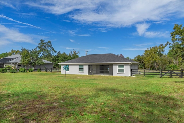 back of house with a yard, a fenced backyard, a chimney, and stucco siding