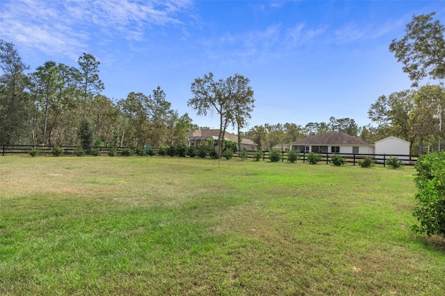 view of yard with a rural view and fence