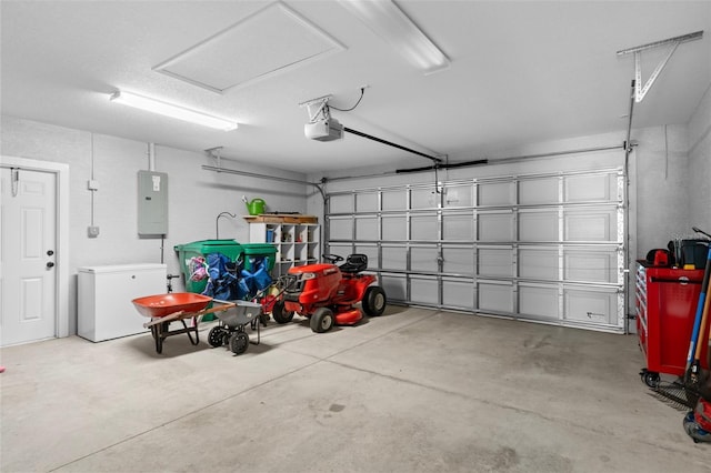 garage featuring electric panel, a garage door opener, and fridge