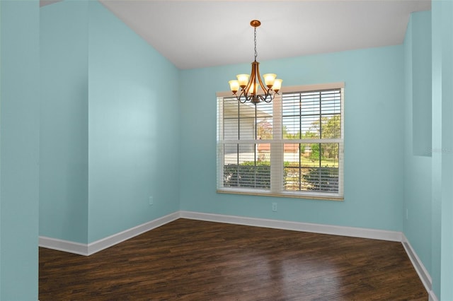 spare room featuring dark wood finished floors, baseboards, and a chandelier