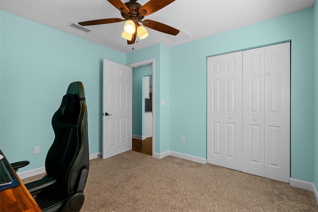 unfurnished office with visible vents, ceiling fan, baseboards, and carpet