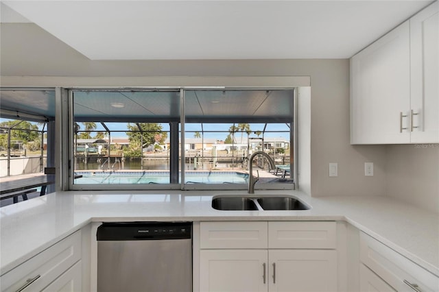 kitchen featuring sink, white cabinets, stainless steel dishwasher, and plenty of natural light