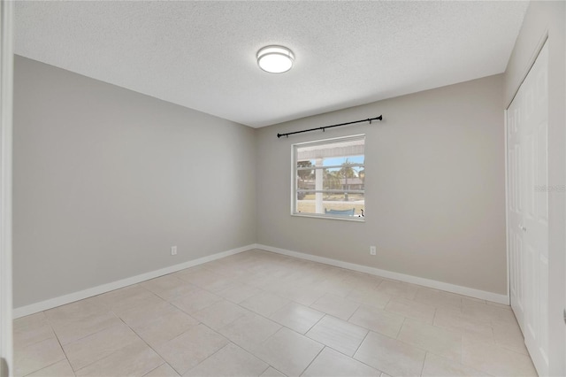 unfurnished room with a textured ceiling