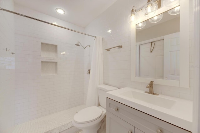 bathroom with toilet, a shower with shower curtain, and vanity